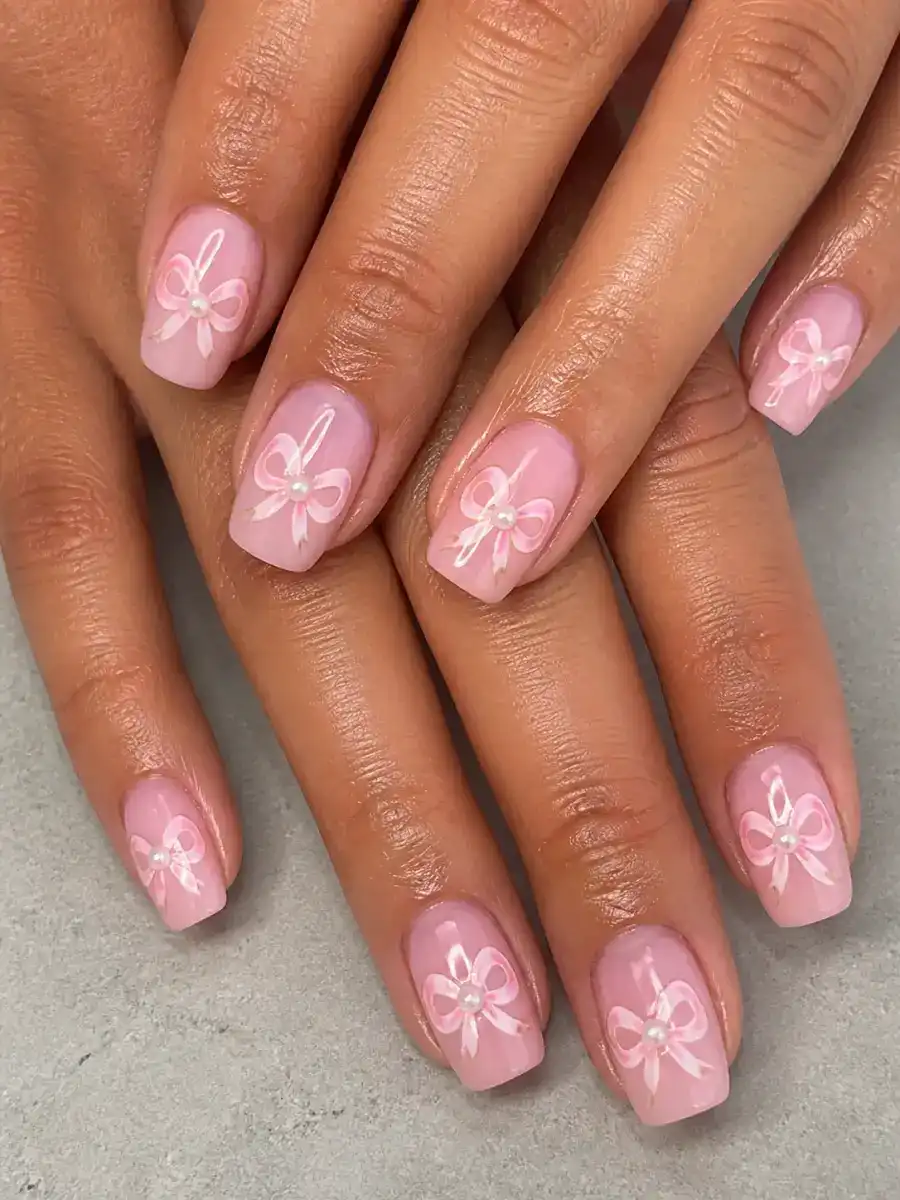 Pearl Bow Nails: pink base, painted bow accent, pearl bow