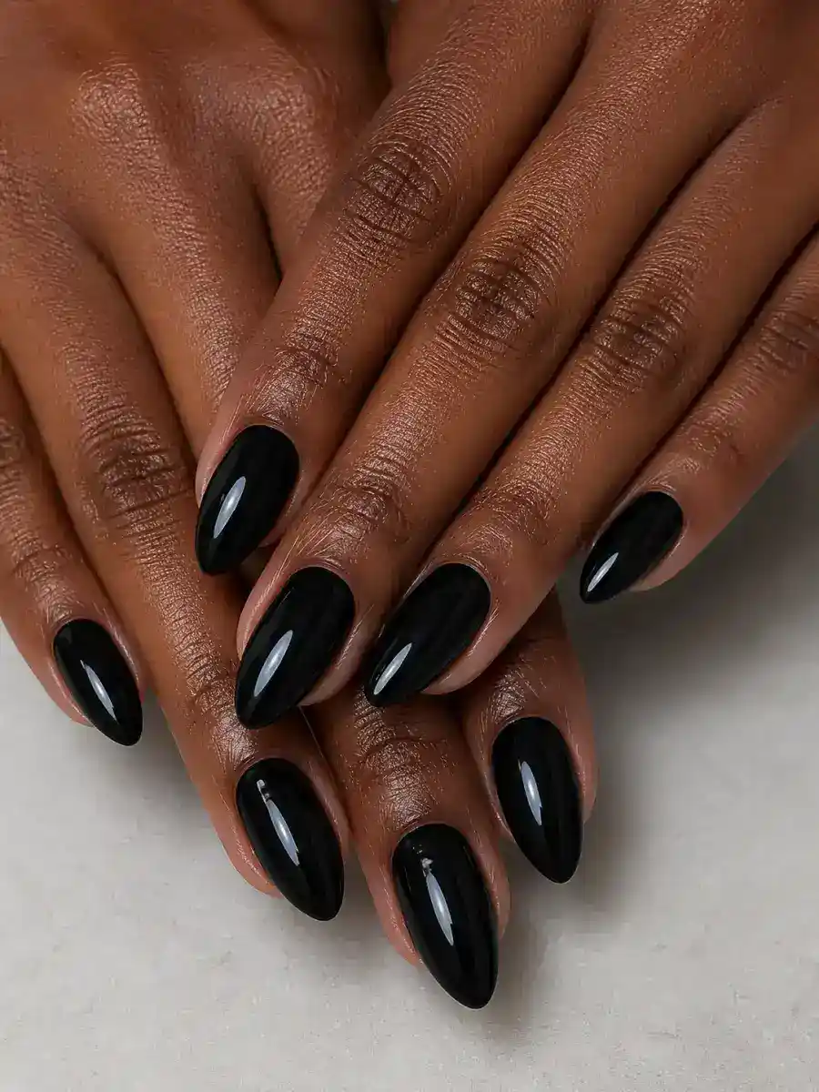 Glossy Black Almond Nails: almond, muted shade, glossy finish, glossy black almond