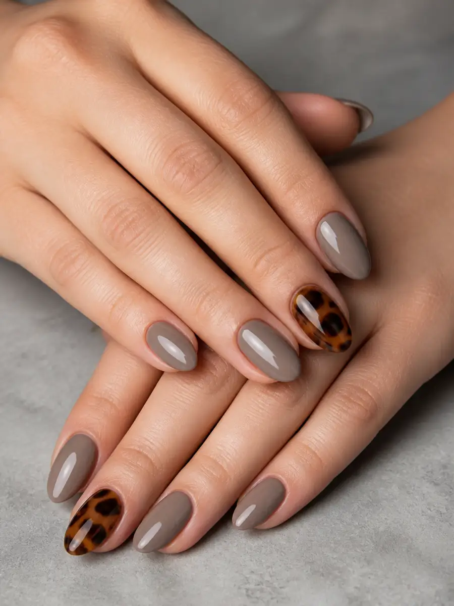 Tortoiseshell Accent Nails: almond, muted shade, glossy finish, tortoiseshell accent