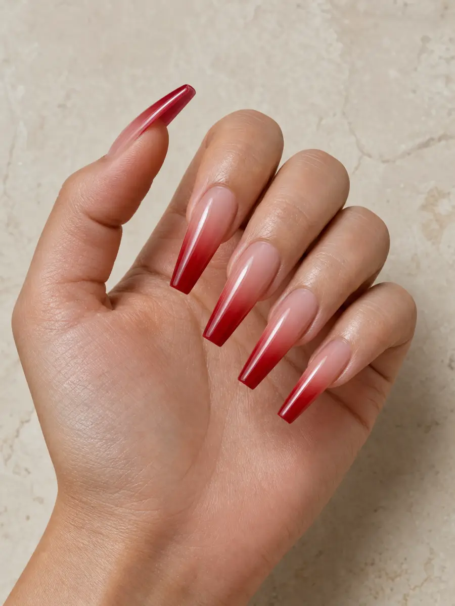 Red Ombre Coffin Nails: long coffin, nude fading into cherry red tips