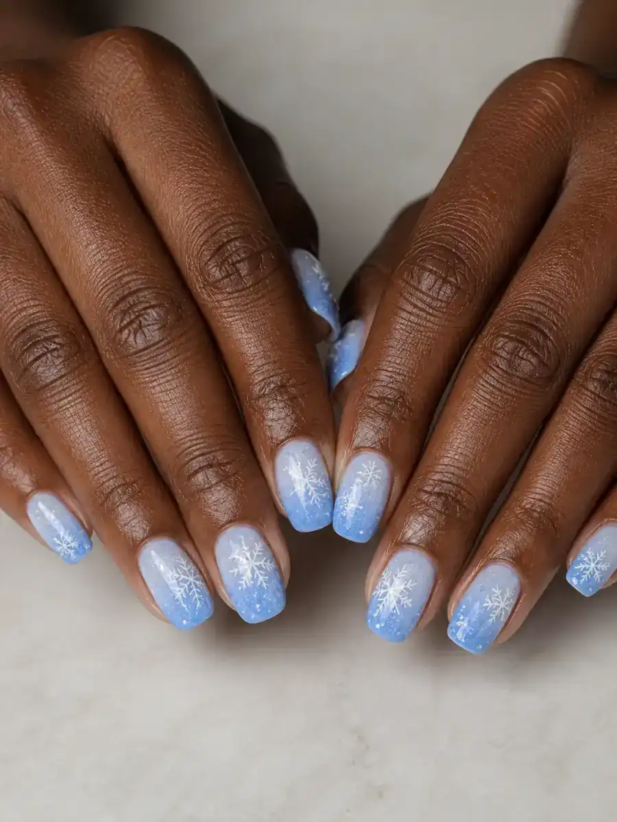 Blue Ombre Snow Nails: white snowflakes on icy blue base, blue ombre snow
